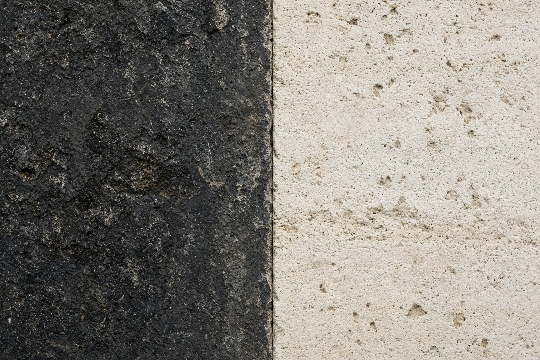 Laser-cleaned limestone against remaining urban soiling, a sharp vertical boundary.